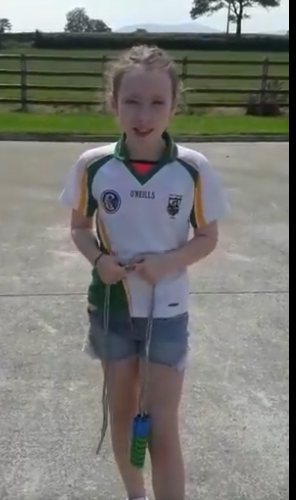Young girl wearing with skipping rope